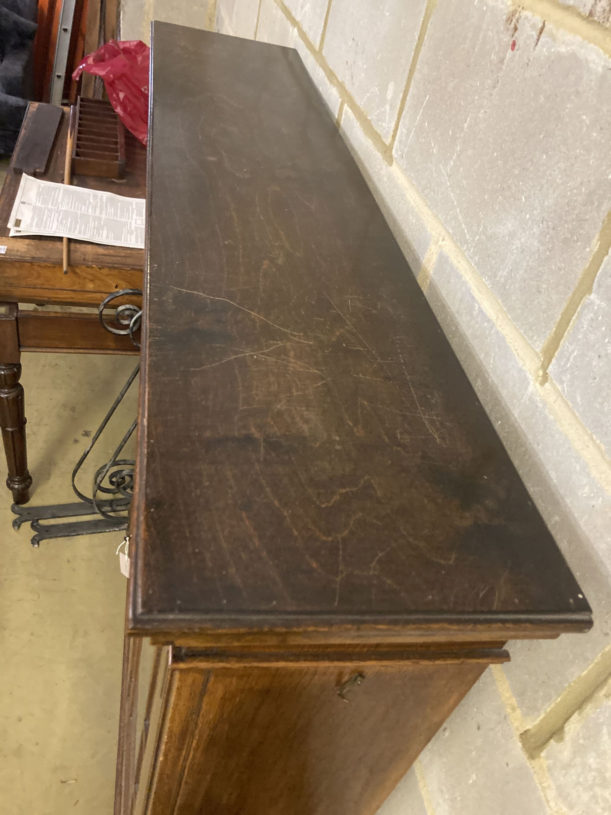 A 1920s glazed oak two door bookcase, length 130cm, depth 29cm, height 156cm